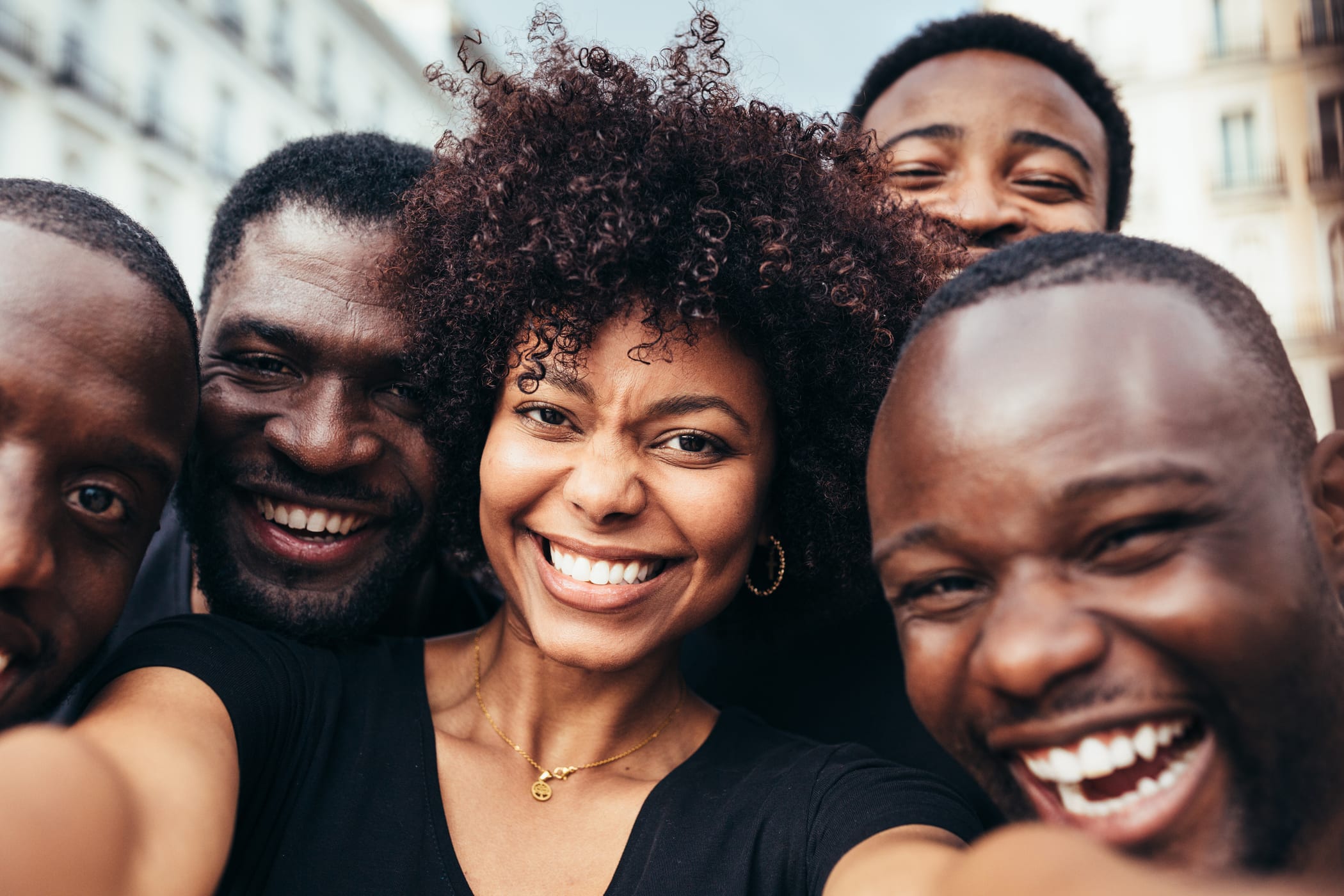 Friends smiling together for a group selfie