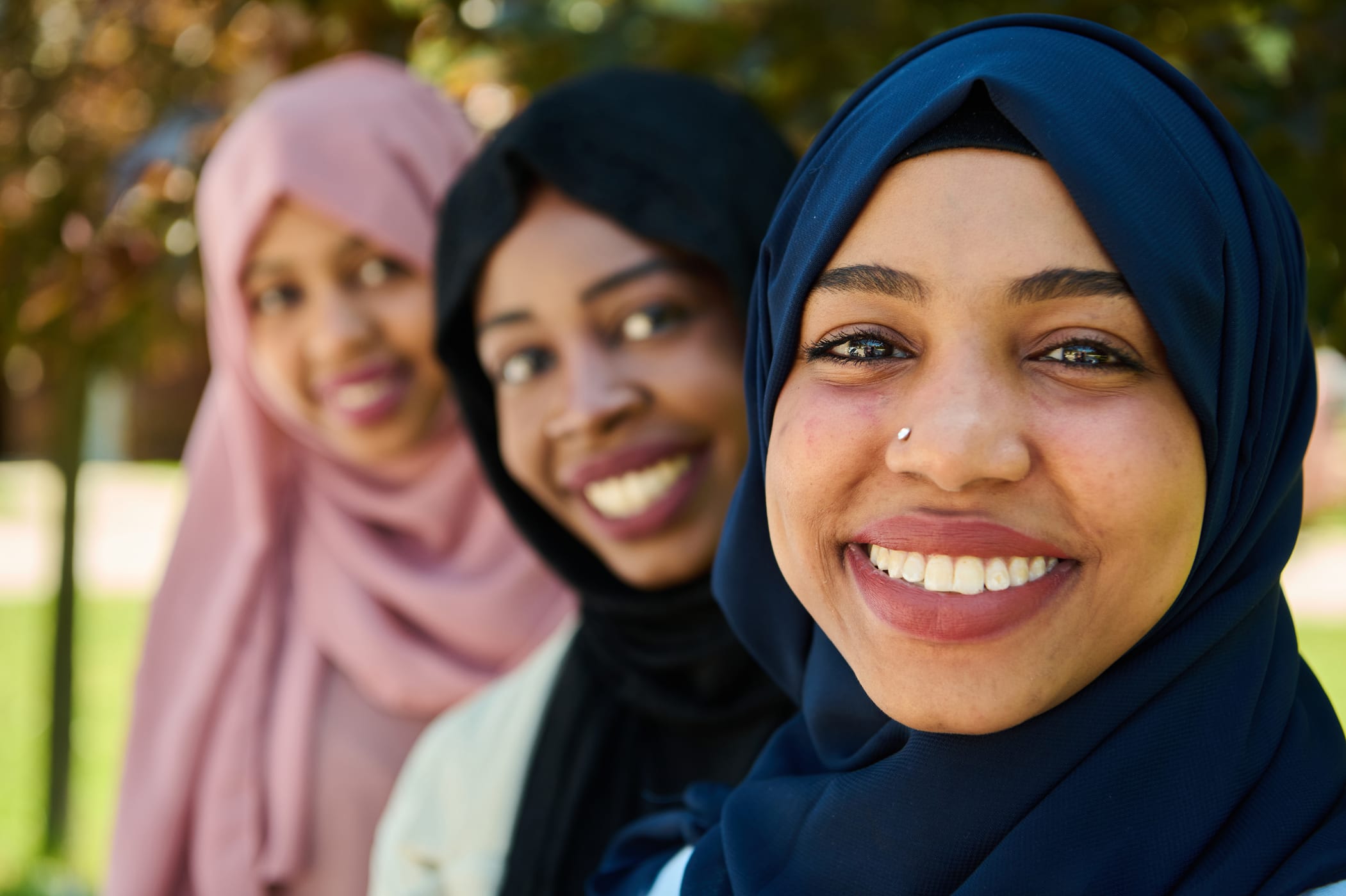 Black Muslim women smiling together outdoors